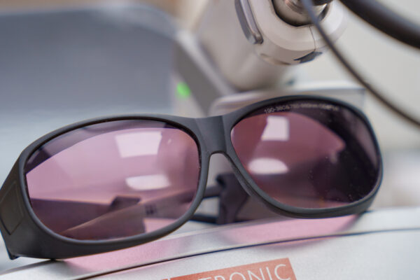 Lutronic Clarity II laser console showing YAG 1064 nm with safety goggles at Glow Lab